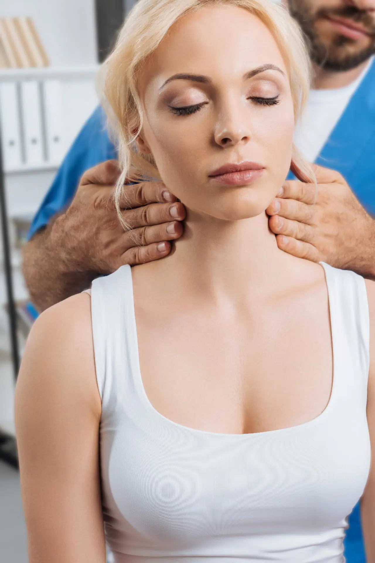 blonde woman getting chiropractic care in Mandeville